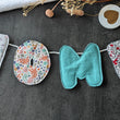 Load image into Gallery viewer, Banderole lettres en tissus matelassées personnalisable, prénom enfant, prénom garçon, prénom fille, mot, décoration intérieure, décoration maison, évènement, anniversaire, guirlande de mot, banderole prénom artisanale, idée cadeau originale, puff letter, les Fantaisies de Malou
